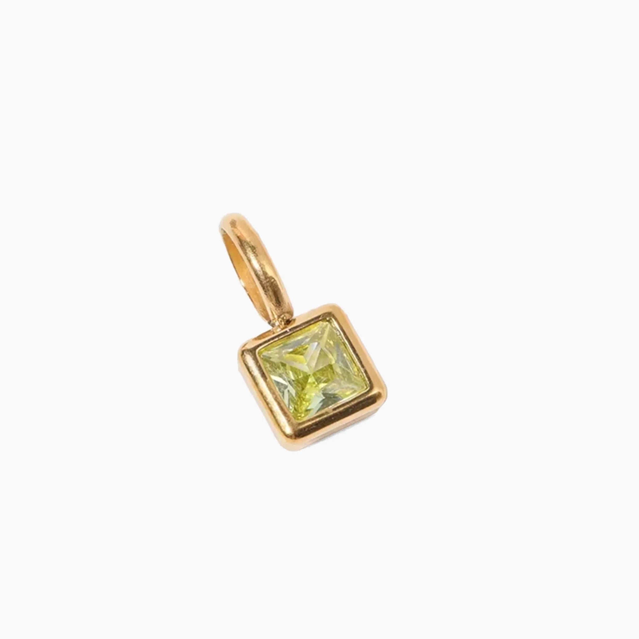 August birthstone charm, golden pendant with a green gemstone on a white background