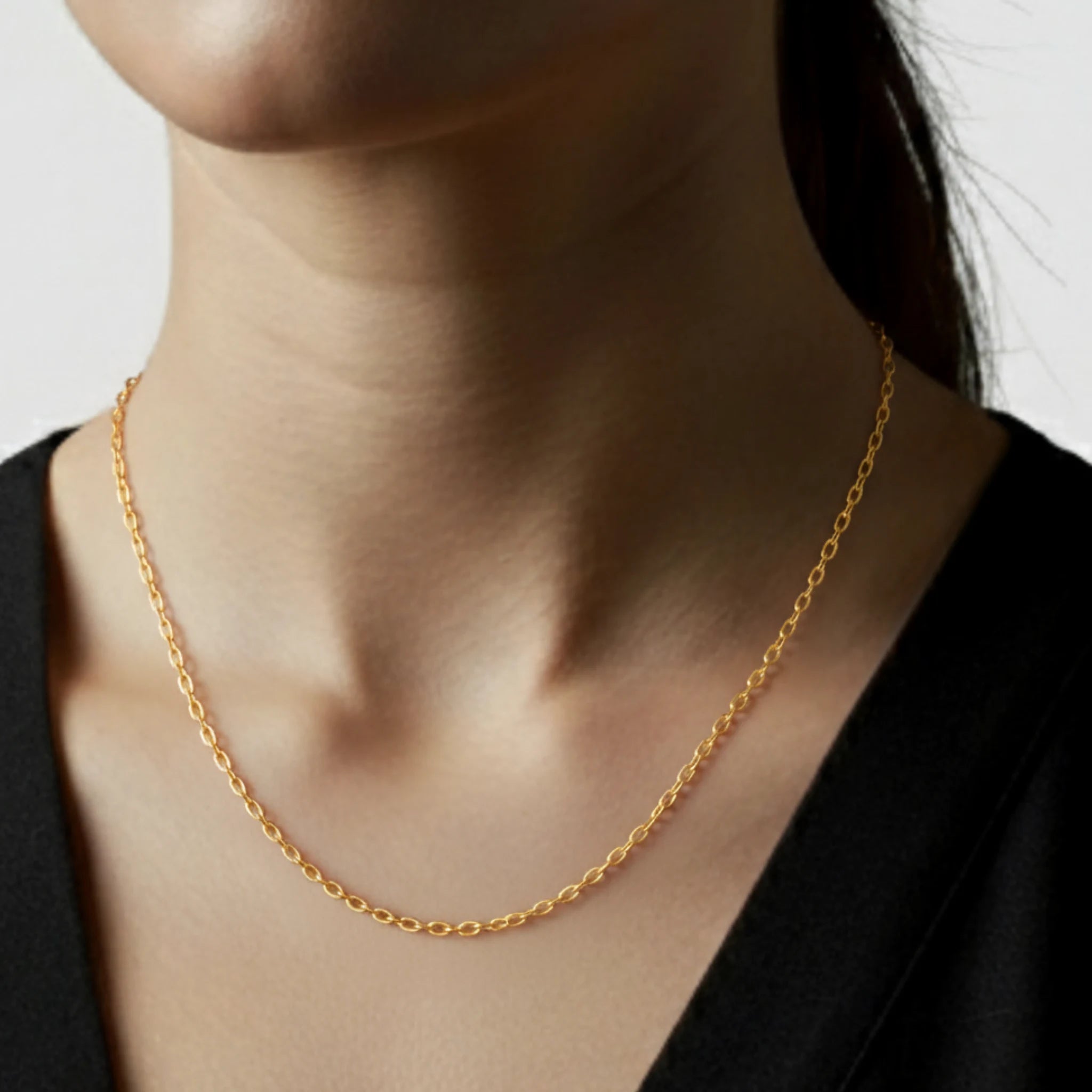 Classic chain long necklace on a person wearing a black shirt