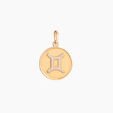 Golden pendant with gemini zodiac symbol on a white background