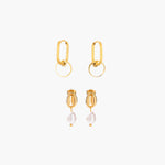 Golden earrings with pearl drops on a white background
