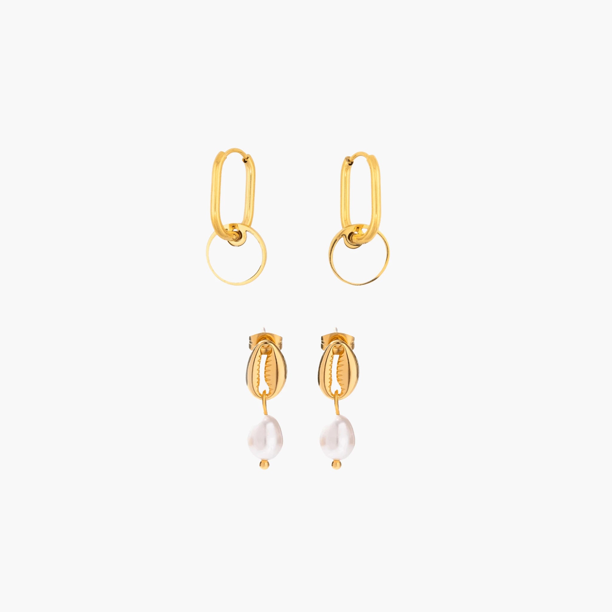 Golden earrings with pearl drops on a white background