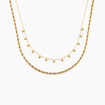 Two golden necklaces on a white background