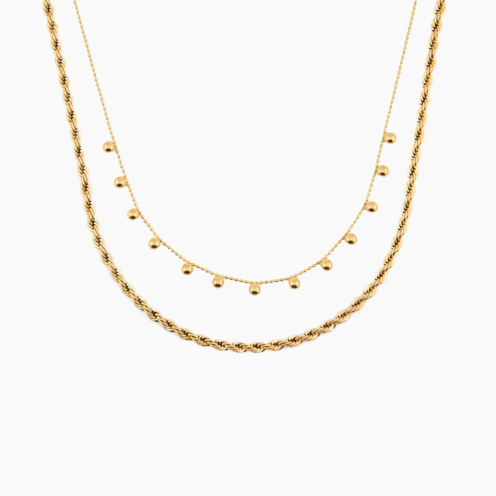 Two golden necklaces on a white background