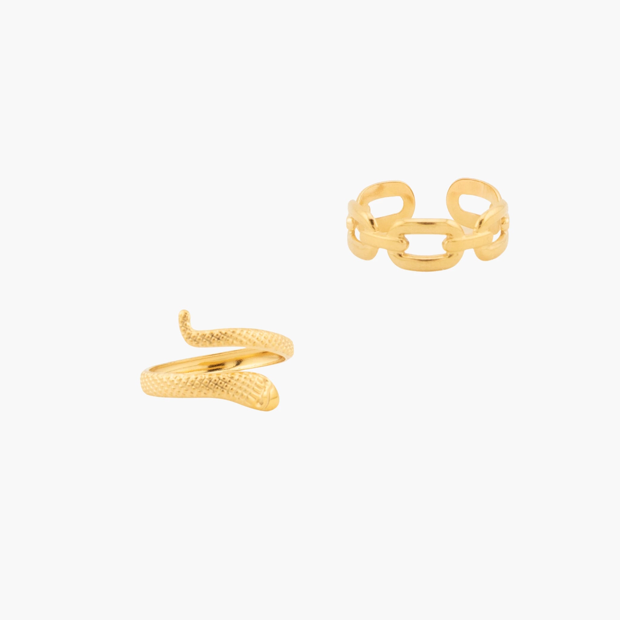 Gold snake-shaped ring and chain link ring on a white background