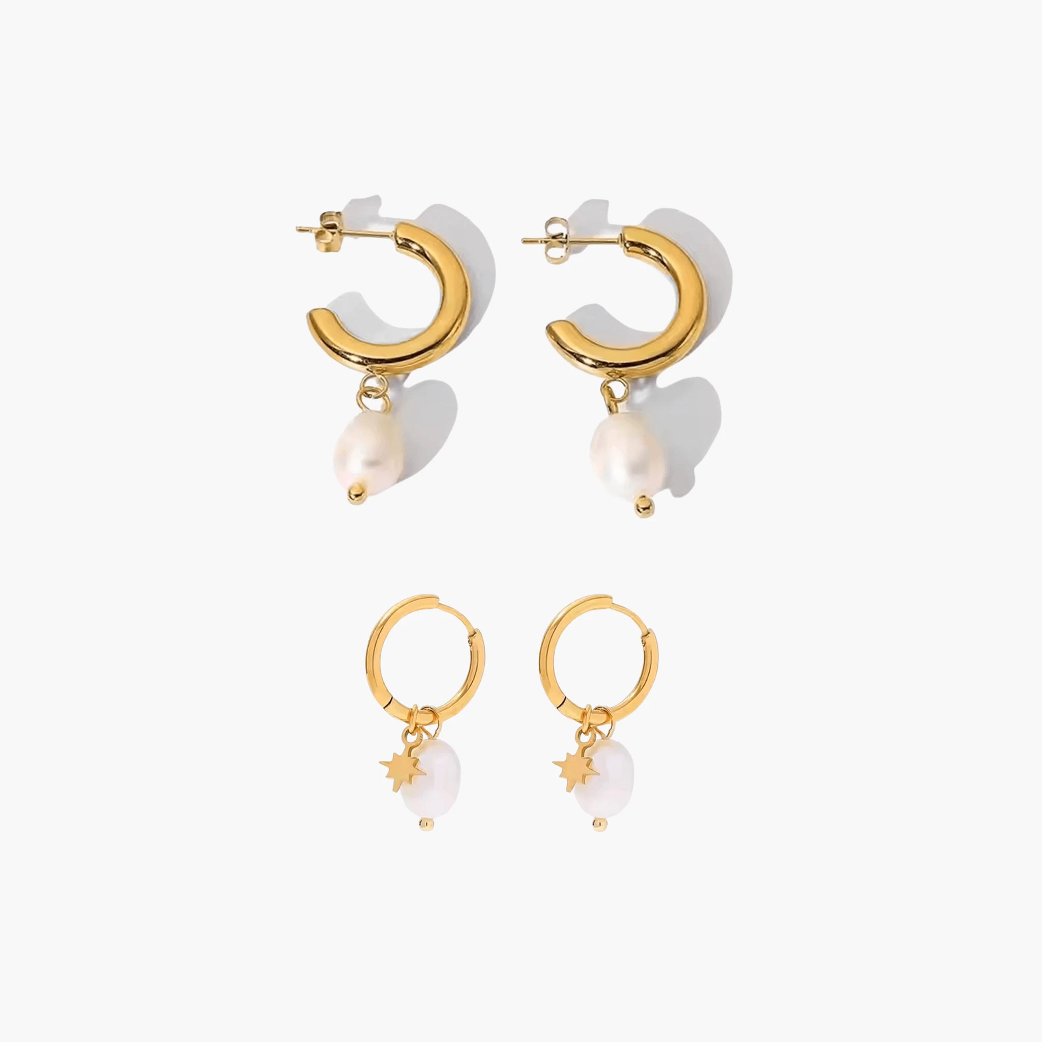 Pair of golden hoop earrings with pearl-like charms on a white background