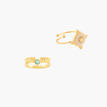 Two gold rings with decorative designs on a white background