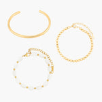 Set of golden bracelets on a white background