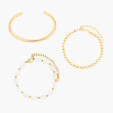 Set of golden bracelets on a white background