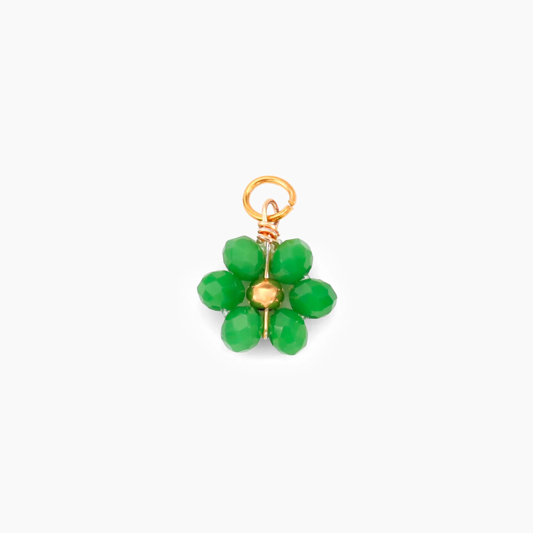 Green flower-shaped charm with gold accents on a white background