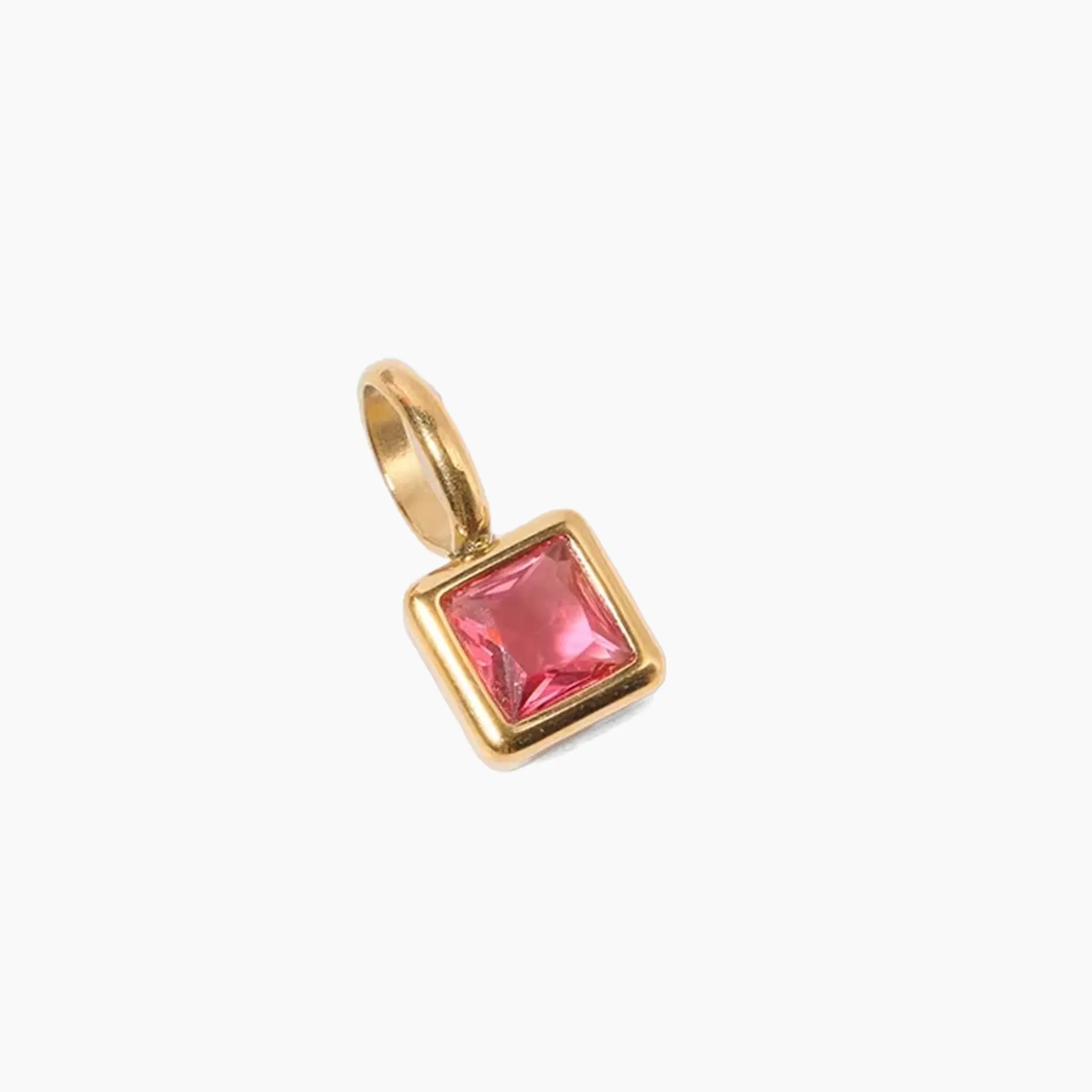 July birthstone charm, golden pendant with a red gemstone on a white background