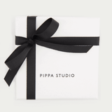 white gift box with black ribbon and pippa studio logo