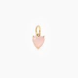 Golden pendant with a pink heart-shaped stone on a white background