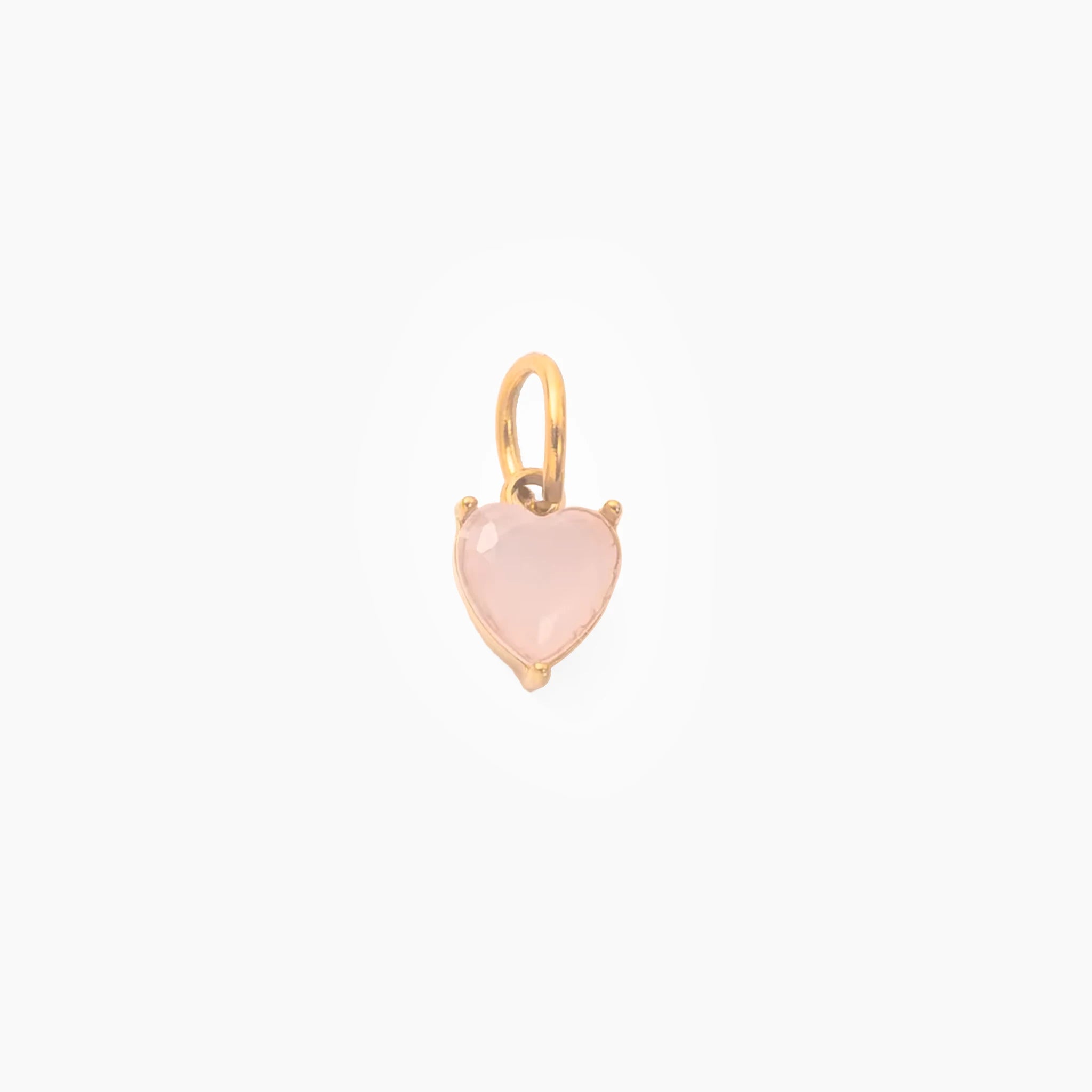 Golden pendant with a pink heart-shaped stone on a white background