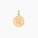 Golden pendant with scorpio zodiac symbol on a white background