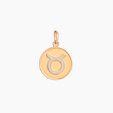 Golden pendant with taurus zodiac symbol on a white background