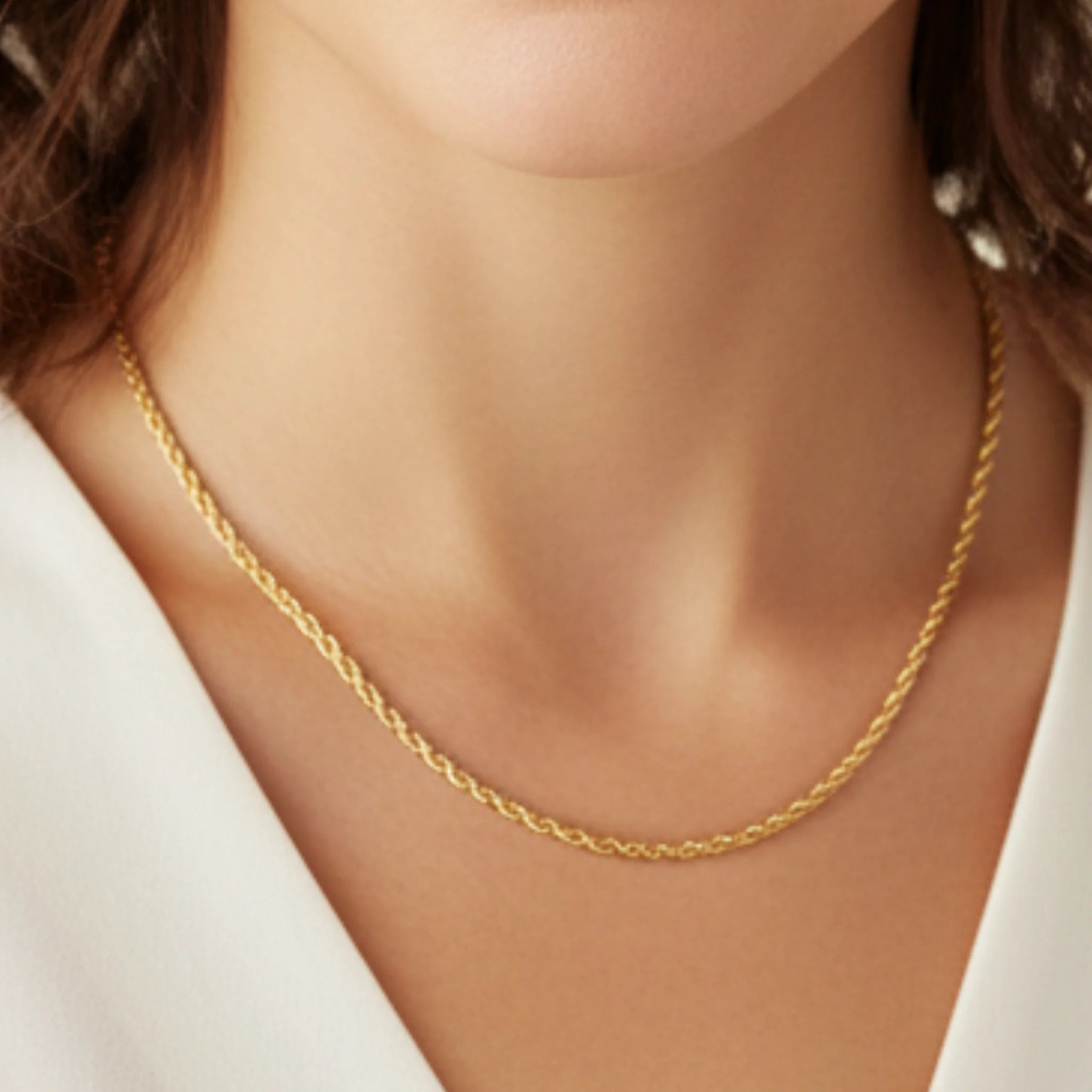 Close-up of a woman wearing a bold twisted rope chain necklace